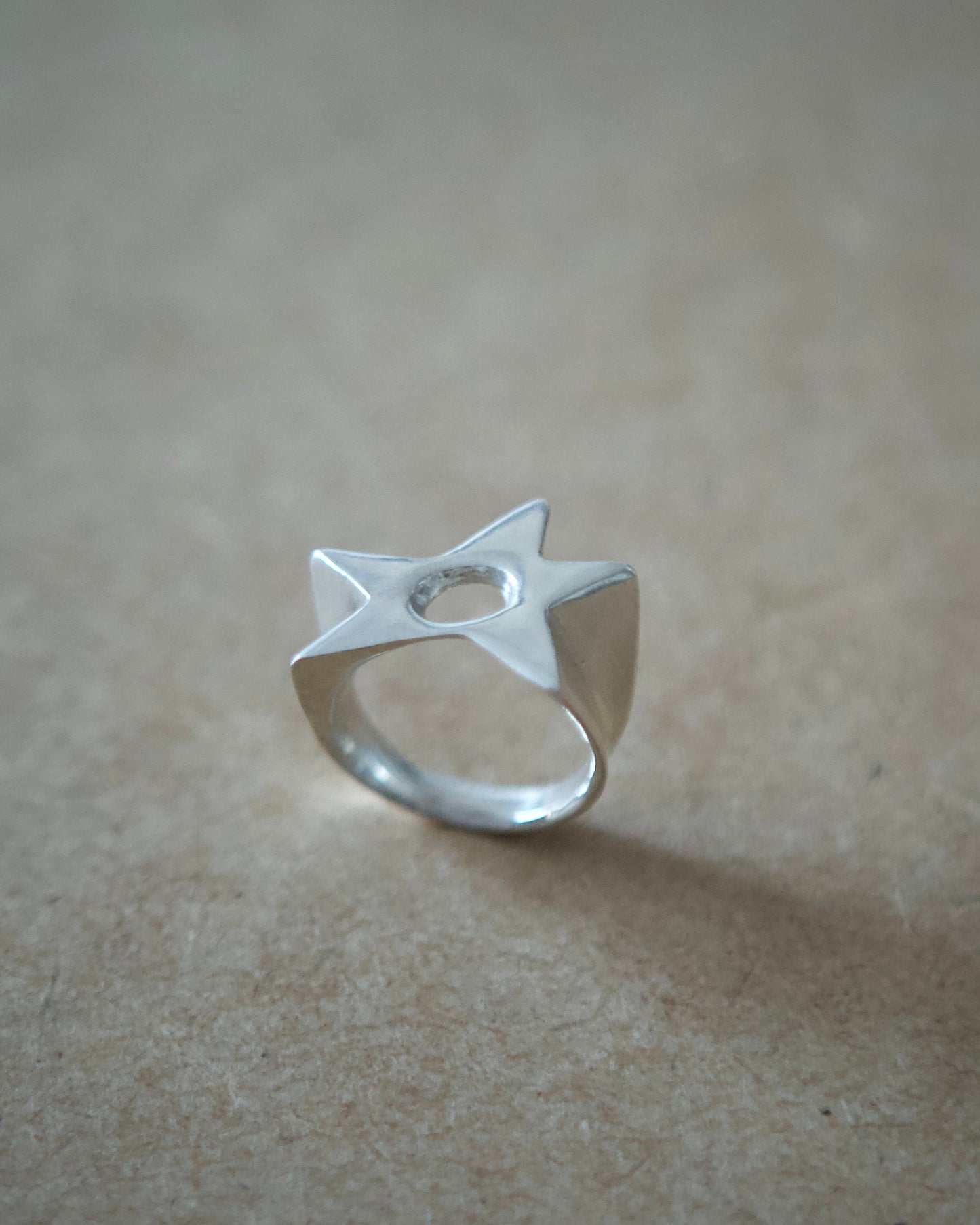 Angled view of handmade sterling silver Aster Ring showing its open adjustable band