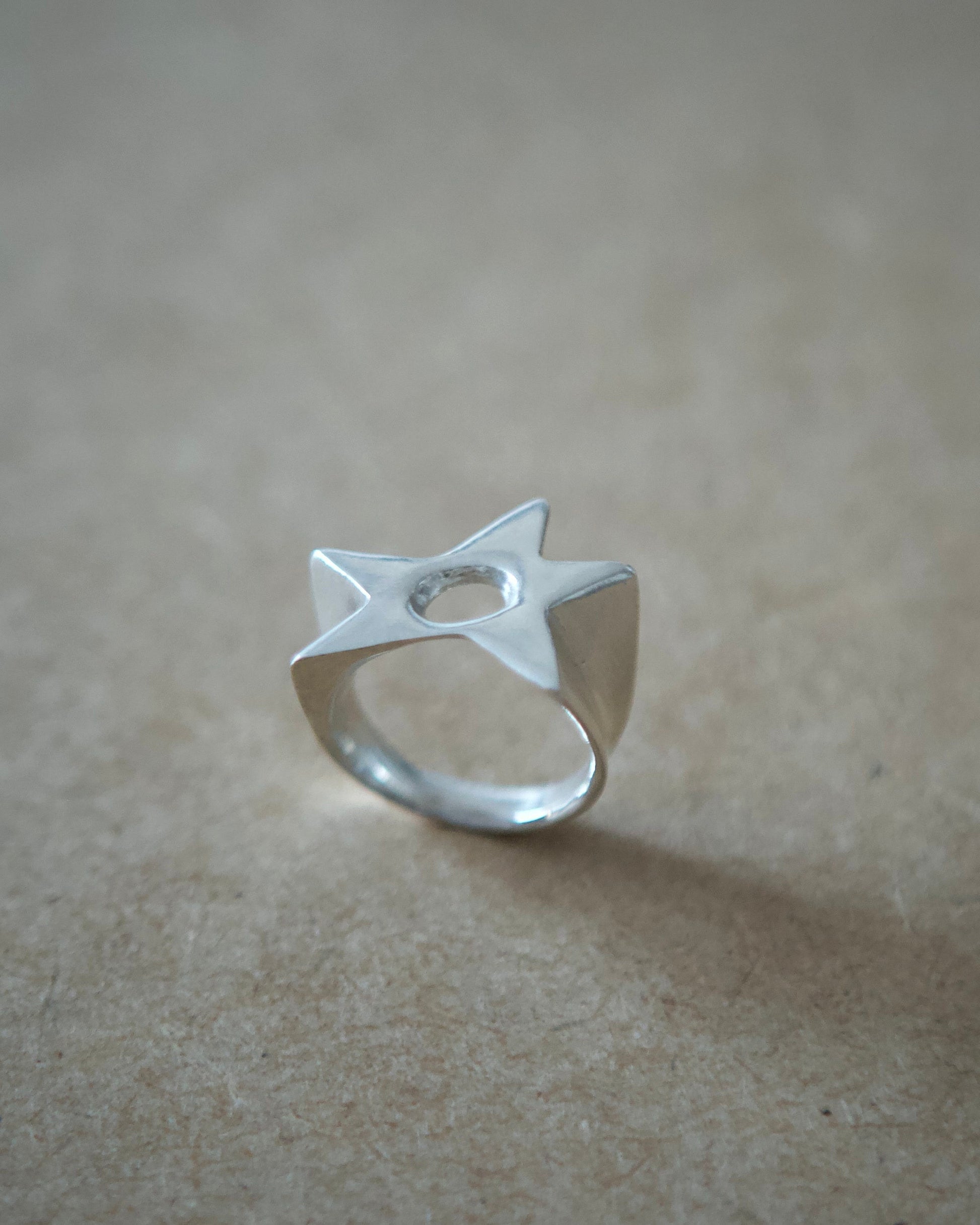 Angled view of handmade sterling silver Aster Ring showing its open adjustable band