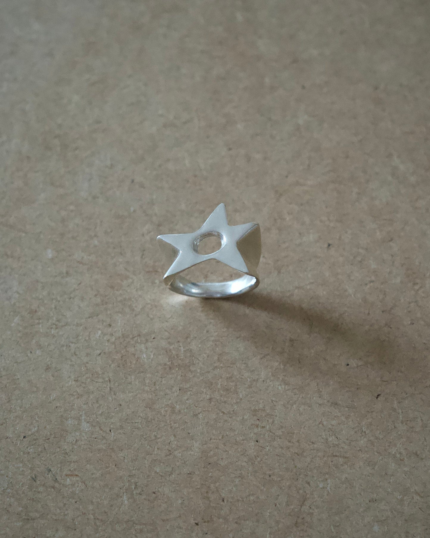 Front view of handmade sterling silver Aster Ring showing the cut-out star face