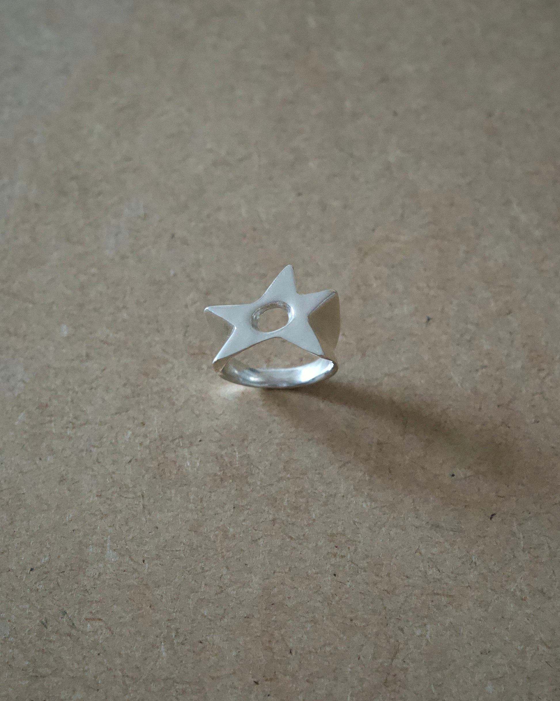 Front view of handmade sterling silver Aster Ring showing the cut-out star face