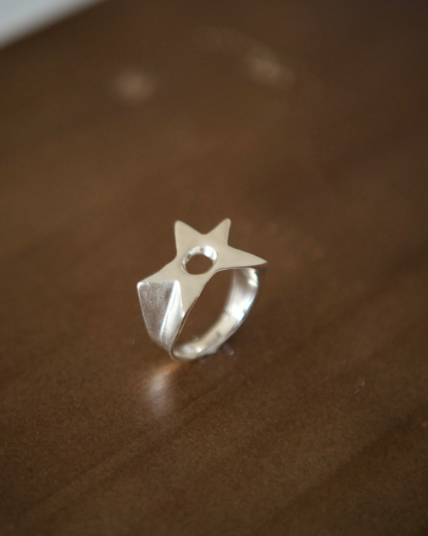 Handmade sterling silver Aster Ring with star-shaped face and open adjustable band